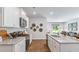 White shaker cabinets, granite countertops, stainless steel appliances, and hardwood floors at 177 Carolina Groves Blvd, Moncks Corner, SC 29461