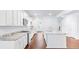 Bright kitchen with white cabinets, granite countertops and hardwood floors at 281 Blue Haw Dr, Moncks Corner, SC 29461