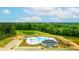 Community pool, playground, and clubhouse with surrounding green space at 281 Blue Haw Dr, Moncks Corner, SC 29461