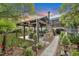 Landscaped backyard with a pergola, patio, and fire pit at 705 S Magnolia St, Summerville, SC 29483