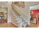 Elegant staircase with white railings and wall decor, leading to the upper level at 705 S Magnolia St, Summerville, SC 29483