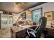 Home office features a large desk, comfortable seating, and French doors leading to the outdoors at 705 S Magnolia St, Summerville, SC 29483