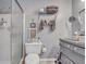 Updated bathroom with walk-in shower, gray vanity, and decorative accents at 705 S Magnolia St, Summerville, SC 29483