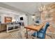 Open concept dining area with rustic wood table and exposed brick wall at 705 S Magnolia St, Summerville, SC 29483