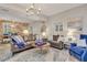 Spacious living room with leather couches, blue accents, and exposed brick at 705 S Magnolia St, Summerville, SC 29483