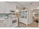 White kitchen with an island and a view into the bedroom at 705 S Magnolia St, Summerville, SC 29483