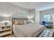 King-size bed in a bedroom with a sitting area and neutral decor at 705 S Magnolia St, Summerville, SC 29483