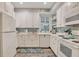 White kitchen with subway tile backsplash and stainless steel appliances at 705 S Magnolia St, Summerville, SC 29483
