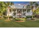 Two-story home with front porch, fountain, and well-manicured lawn at 705 S Magnolia St, Summerville, SC 29483