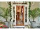 Inviting entryway with double doors, ornate chandelier, and decorative accents at 705 S Magnolia St, Summerville, SC 29483