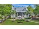 Two-story home with metal roof, porch, and fountain at 705 S Magnolia St, Summerville, SC 29483