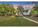 Two-story home with metal roof, porch, and landscaped yard at 705 S Magnolia St, Summerville, SC 29483