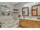 Elegant bathroom with double vanity, jacuzzi tub, and stylish light fixtures at 705 S Magnolia St, Summerville, SC 29483