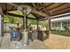 Outdoor patio with fireplace, seating area, and covered structure at 705 S Magnolia St, Summerville, SC 29483