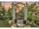 Landscaped backyard with brick patio, arbor, and lush greenery at 705 S Magnolia St, Summerville, SC 29483