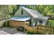 House exterior with metal roof, wooden fence, and covered carport at 705 S Magnolia St, Summerville, SC 29483