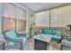 Cozy screened porch with wicker furniture and a fire pit at 705 S Magnolia St, Summerville, SC 29483