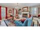 Spacious living room with a fireplace, comfortable seating, and large windows at 705 S Magnolia St, Summerville, SC 29483