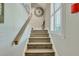 Elegant wooden staircase with light-colored wood and a simple handrail at 705 S Magnolia St, Summerville, SC 29483