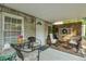 Relaxing covered patio with wicker chairs and a small table at 705 S Magnolia St, Summerville, SC 29483