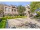 Two story home with brick and stucco exterior, lush landscaping, and courtyard at 40 Laurens St, Charleston, SC 29401