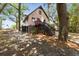 Two-story cottage with whimsical exterior paint, dark stairs, and lush landscaping at 218 E Huron Ave, Folly Beach, SC 29439