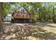 Two-story cottage with deck, whimsical exterior paint, and lush landscaping at 218 E Huron Ave, Folly Beach, SC 29439