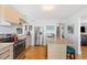 Modern kitchen with island, stainless steel appliances and granite countertops at 218 E Huron Ave, Folly Beach, SC 29439