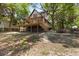 Two-story cottage with deck, whimsical exterior paint, and lush landscaping at 218 E Huron Ave, Folly Beach, SC 29439