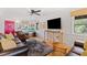 Living room with leather sofas, hardwood floors, and large TV at 218 E Huron Ave, Folly Beach, SC 29439