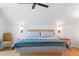 Bright bedroom with a queen bed and wood floors at 218 E Huron Ave, Folly Beach, SC 29439