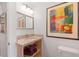 Small bathroom with granite vanity and colorful art at 218 E Huron Ave, Folly Beach, SC 29439