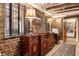 Basement hallway with exposed brick walls and antique furniture at 40 Laurens St, Charleston, SC 29401