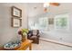Cozy sitting area with leather chair, hardwood floors, and natural light at 933 Mccants Dr, Mount Pleasant, SC 29464