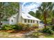 Charming white cottage with metal roof and landscaping at 933 Mccants Dr, Mount Pleasant, SC 29464