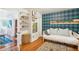 Playroom with daybed, teal patterned walls, and built in shelves at 933 Mccants Dr, Mount Pleasant, SC 29464