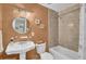 A peach-toned bathroom with a pedestal sink and shower/tub combo at 1510 Jahnz Ave, Summerville, SC 29485