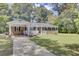 Brick ranch house with carport, front porch, and landscaped lawn at 1510 Jahnz Ave, Summerville, SC 29485