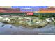 Aerial view of a 3.46-acre property in Johns Island, featuring a house and lush greenery at 000 Remington Trl, Johns Island, SC 29455