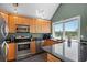 Modern kitchen with wood cabinets, granite countertops, and stainless steel appliances at 2473 High Hammock Rd, Seabrook Island, SC 29455