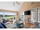 Bright living room with vaulted ceilings, hardwood floors, and access to a screened porch at 2473 High Hammock Rd, Seabrook Island, SC 29455