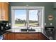 Kitchen with granite countertops, double sink, and a view of the outdoors at 2473 High Hammock Rd, Seabrook Island, SC 29455