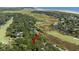 Aerial view showing home nestled in a wooded area near water at 2473 High Hammock Rd, Seabrook Island, SC 29455