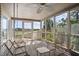 Spacious screened porch with multiple seating options and scenic views at 2473 High Hammock Rd, Seabrook Island, SC 29455
