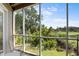 Relaxing screened porch overlooks a lush green backyard and scenic landscape at 2473 High Hammock Rd, Seabrook Island, SC 29455