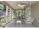 Relaxing screened porch with ceiling fan, hammock, and rocking chairs at 2473 High Hammock Rd, Seabrook Island, SC 29455