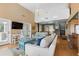 Open living space with high ceilings, hardwood floors, and views to the dining area at 2473 High Hammock Rd, Seabrook Island, SC 29455
