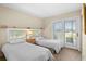 Comfortable bedroom with two twin beds and private balcony access at 2473 High Hammock Rd, Seabrook Island, SC 29455