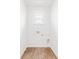Small laundry room with wood-look flooring and a window at 756 Long Bluff Rd, Summerville, SC 29486