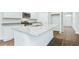 Kitchen island with granite countertop and white cabinets at 756 Long Bluff Rd, Summerville, SC 29486